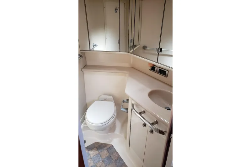 Slide: The Image of Bathroom interior of 2004 Sea Ray 550 Sundancer yacht, featuring toilet and sink. - 74