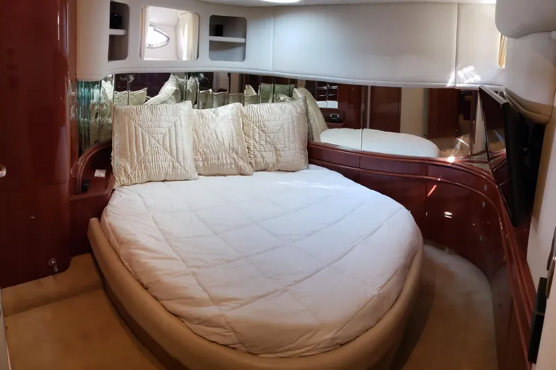 Slide: The Image of Luxurious bedroom interior of 2004 Sea Ray 550 Sundancer yacht with plush bedding. - 76