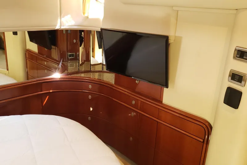 Slide: The Image of Luxurious 2004 Sea Ray 550 Sundancer cabin with TV and elegant wood cabinetry. - 77