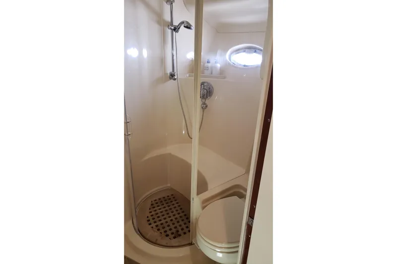 Slide: The Image of Bathroom interior of 2004 Sea Ray 550 Sundancer yacht, featuring shower and toilet. - 78