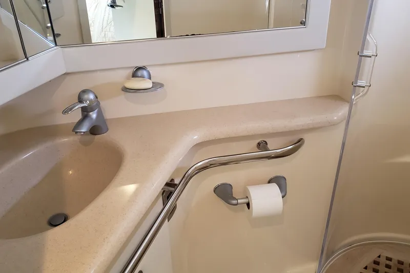 Slide: The Image of Bathroom sink area in 2004 Sea Ray 550 Sundancer yacht, featuring modern fixtures. - 79