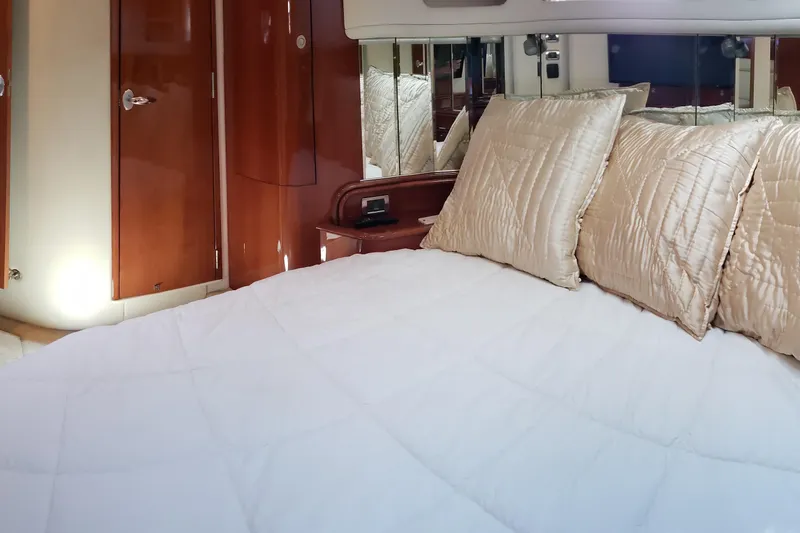 Slide: The Image of Luxurious cabin interior of 2004 Sea Ray 550 Sundancer yacht with plush bedding. - 80
