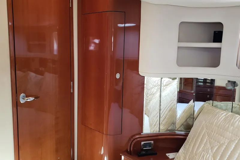 Slide: The Image of Interior of 2004 Sea Ray 550 Sundancer yacht with wood paneling and mirrored accents. - 81
