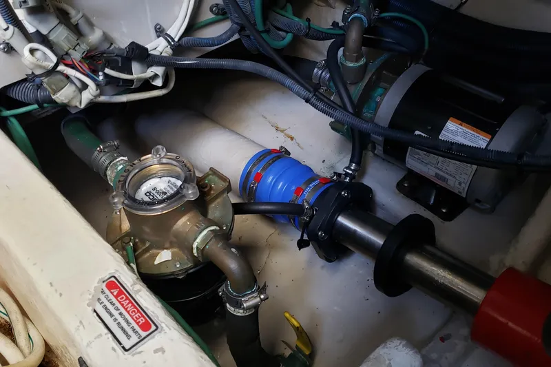 Slide: The Image of Engine compartment of a 2004 Sea Ray 550 Sundancer with visible mechanical components. - 90