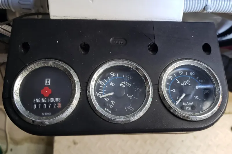 Slide: The Image of Instrument panel of a 2004 Sea Ray 550 Sundancer showing engine hours and gauges. - 93