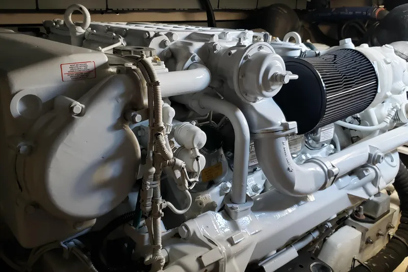 Slide: The Image of Engine of a 2004 Sea Ray 550 Sundancer yacht, showcasing intricate mechanical components. - 94