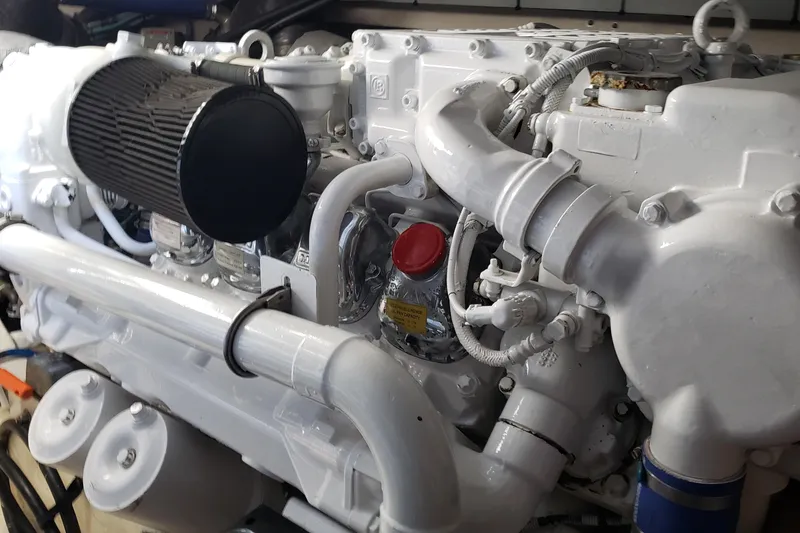 Slide: The Image of Engine of a 2004 Sea Ray 550 Sundancer yacht, showcasing intricate mechanical components. - 95