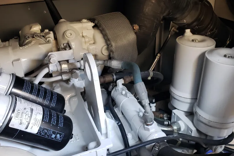 Slide: The Image of Engine compartment of a 2004 Sea Ray 550 Sundancer boat, showcasing mechanical components. - 97