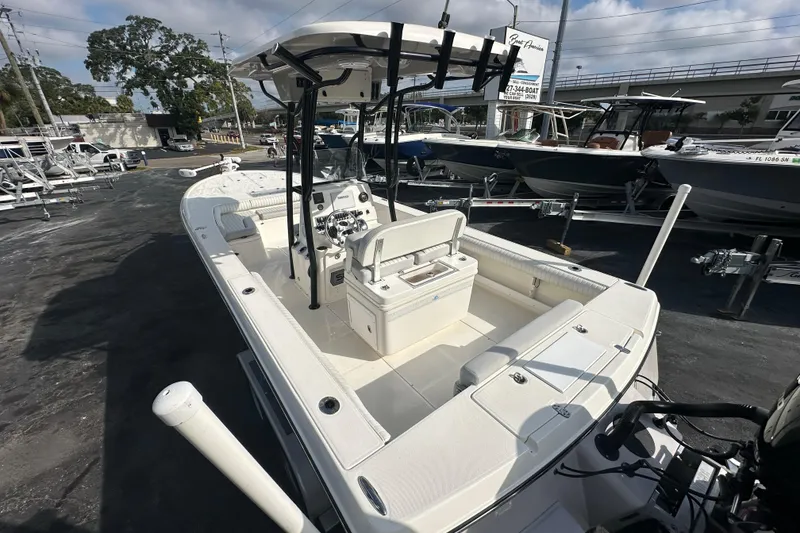 Slide: The Image of 2018 Sea Born FX25 Bay boat with center console and seating, displayed outdoors. - 10