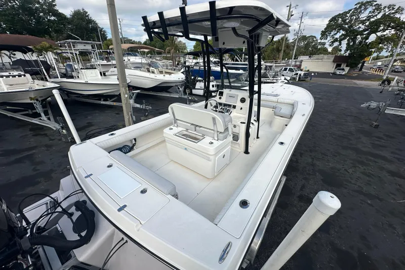 Slide: The Image of 2018 Sea Born FX25 Bay boat with center console and seating, parked in a marina. - 11