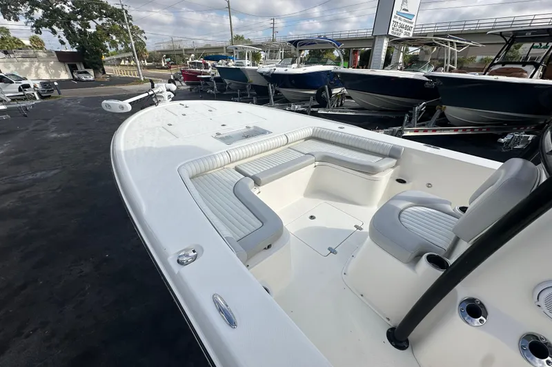 Slide: The Image of 2018 Sea Born FX25 Bay boat with spacious seating and sleek design in a dealership lot. - 14