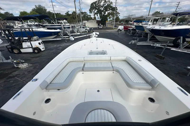 Slide: The Image of 2018 Sea Born FX25 Bay boat with spacious seating, parked in a marina. - 18