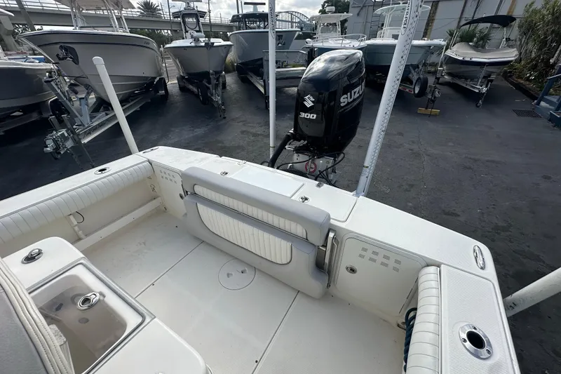 Slide: The Image of 2018 Sea Born FX25 Bay boat with Suzuki 300 engine, docked among other boats. - 22