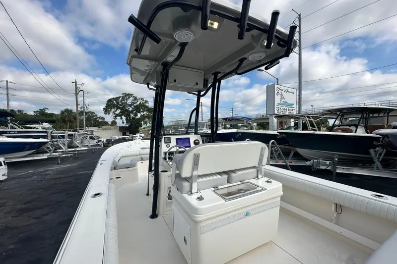 Slide: The Image of 2018 Sea Born FX25 Bay boat interior with console and seating, displayed at a dealership. - 26