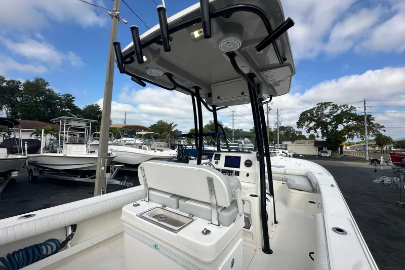 Slide: The Image of 2018 Sea Born FX25 Bay boat with T-top and console, parked in a marina. - 27