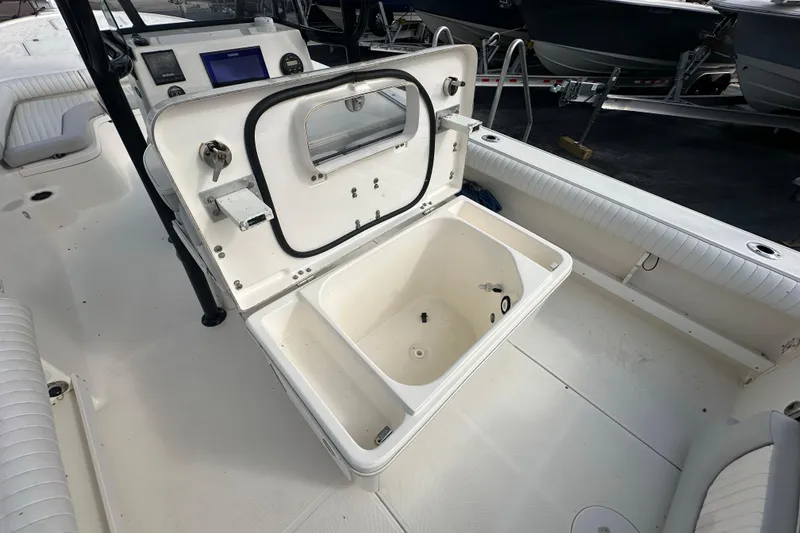 Slide: The Image of 2018 Sea Born FX25 Bay boat interior with open storage compartment. - 28
