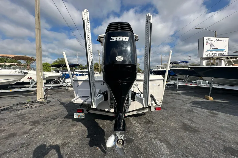 Slide: The Image of 2018 Sea Born FX25 Bay boat with 300 horsepower engine, parked in a marina. - 4