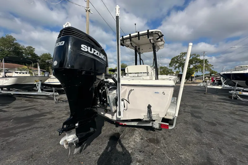 Slide: The Image of 2018 Sea Born FX25 Bay boat with Suzuki outboard motor in a marina setting. - 5