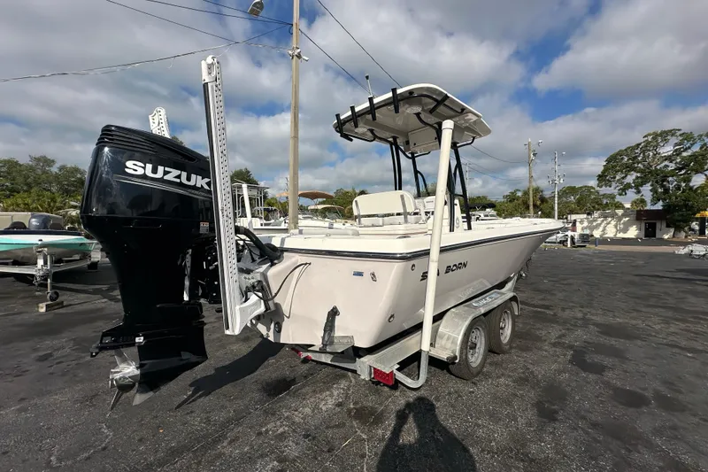 Slide: The Image of 2018 Sea Born FX25 Bay boat with Suzuki engine on a trailer in a parking lot. - 6