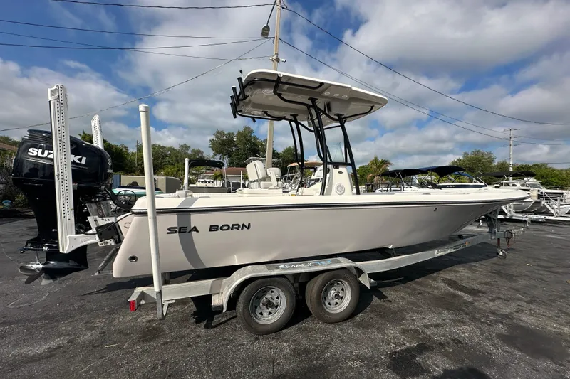 Slide: The Image of 2018 Sea Born FX25 Bay boat on trailer, featuring Suzuki outboard motor. - 7
