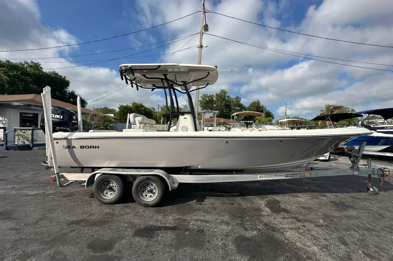 Slide: The Image of 2018 Sea Born FX25 Bay boat on trailer under cloudy sky. - 8