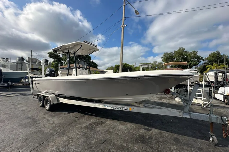Slide: The Image of 2018 Sea Born FX25 Bay boat on trailer under cloudy sky. - 9