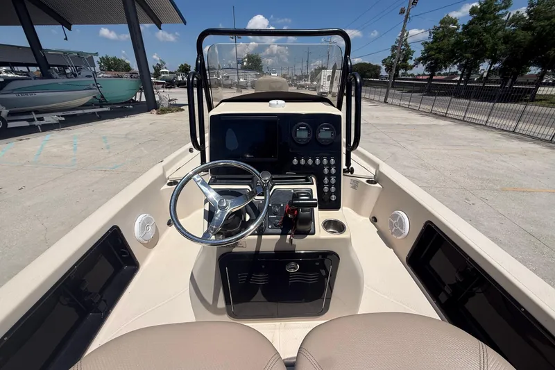 Slide: The Image of 2016 Blue Wave 2200 PureBay boat dashboard with steering wheel and control panel. - 13
