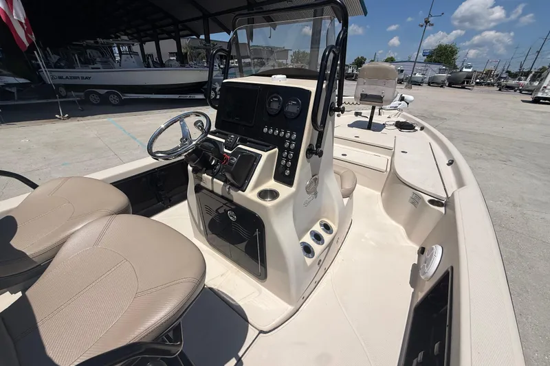 Slide: The Image of 2016 Blue Wave 2200 PureBay boat interior with steering console and seating. - 15