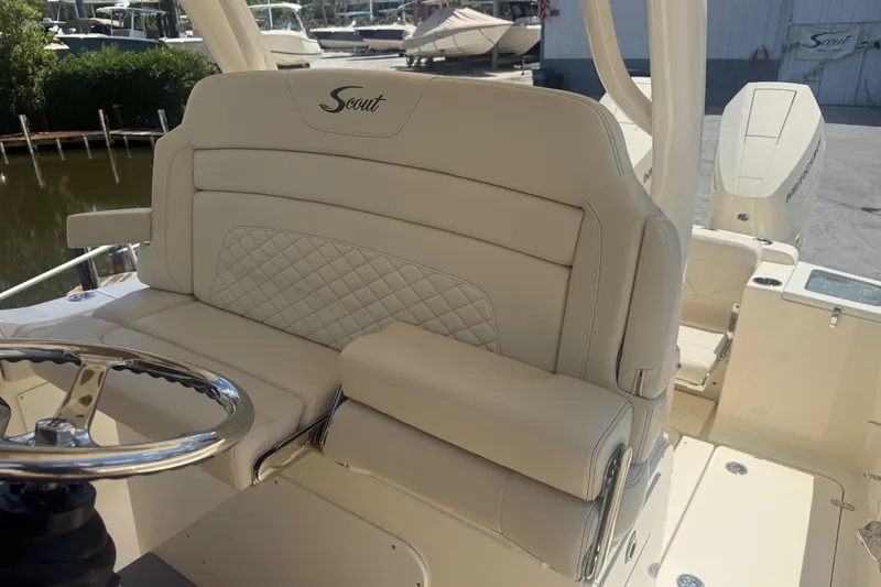 Slide: The Image of Luxurious interior of 2025 Scout 330 LXF boat with plush seating and steering wheel. - 10
