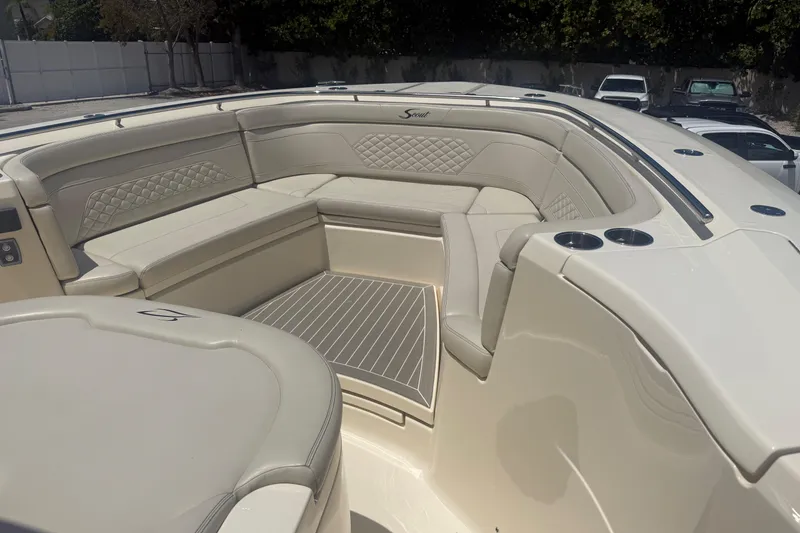 Slide: The Image of Luxurious seating area on a 2025 Scout 330 LXF boat, featuring elegant upholstery and cup holders. - 13