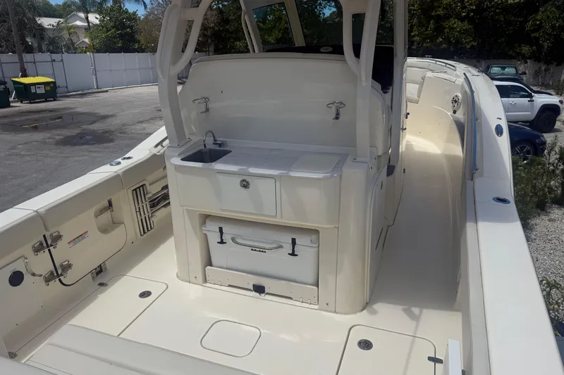 Slide: The Image of 2025 Scout 330 LXF boat interior with sink and storage area. - 5