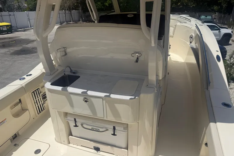 Slide: The Image of 2025 Scout 330 LXF boat interior with sink and storage area. - 7