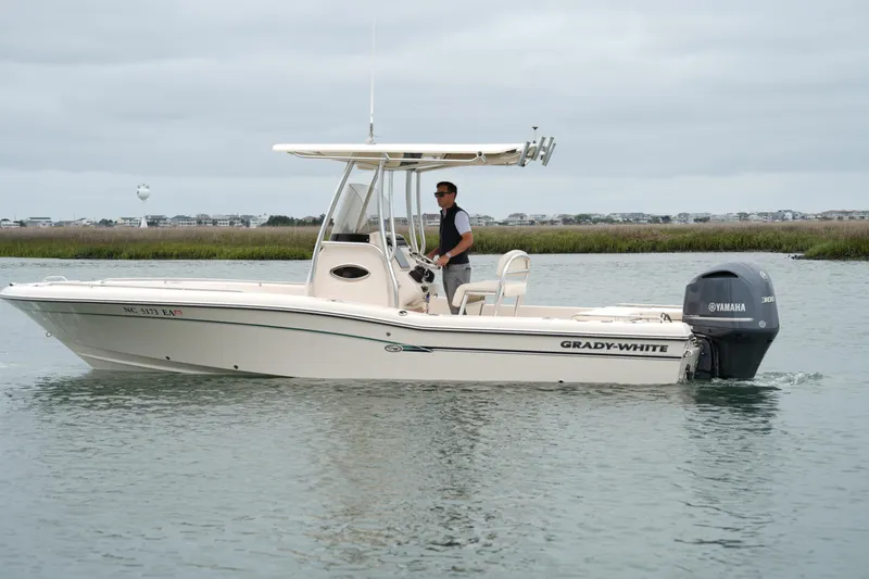 Slide: The Image of 2015 Grady-White 251 Coastal Explorer boat cruising on calm waters. - 11