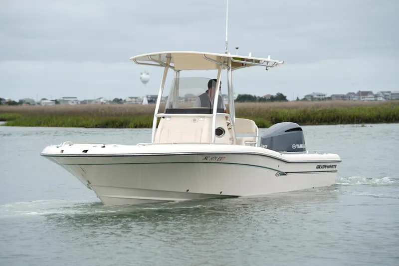 Slide: The Image of 2015 Grady-White 251 Coastal Explorer boat cruising on calm waters. - 12