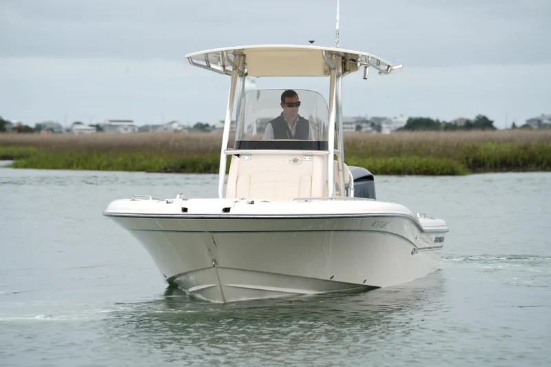 Slide: The Image of 2015 Grady-White 251 Coastal Explorer boat navigating calm waters. - 13