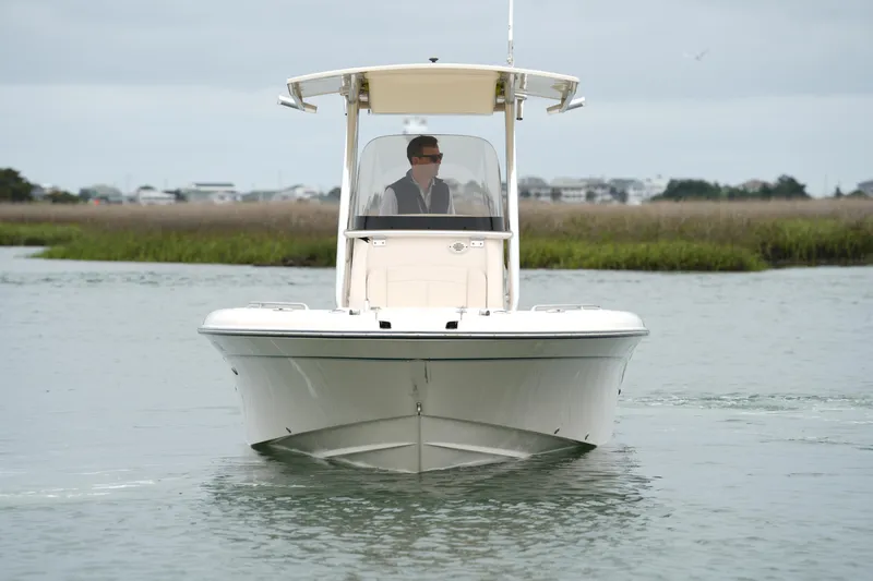 Slide: The Image of 2015 Grady-White 251 Coastal Explorer boat navigating calm waters. - 14