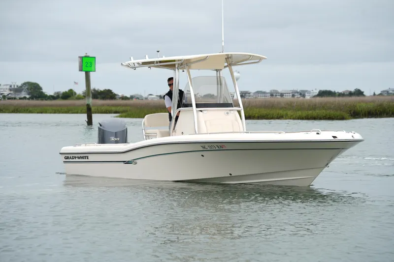Slide: The Image of 2015 Grady-White 251 Coastal Explorer boat cruising on calm waters. - 16