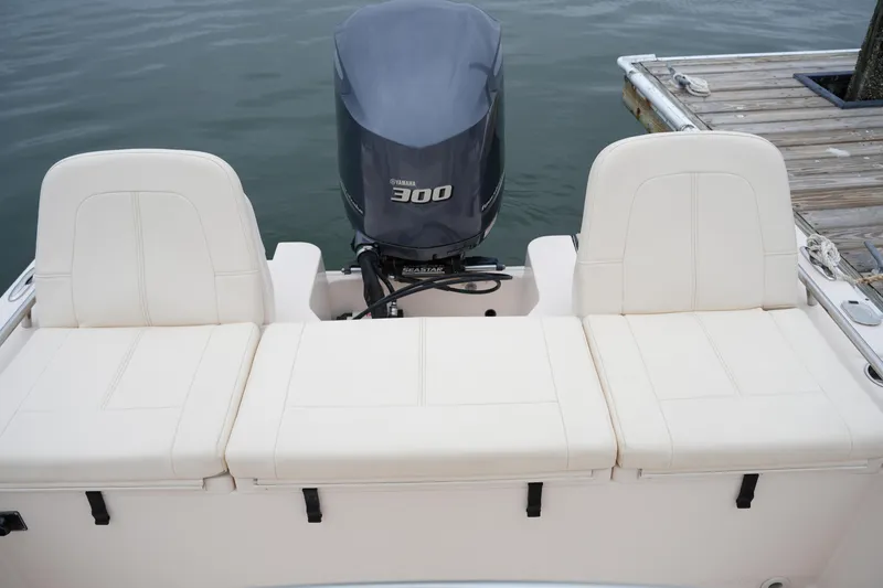 Slide: The Image of 2015 Grady-White 251 Coastal Explorer boat with Yamaha 300 engine, docked by the water. - 18