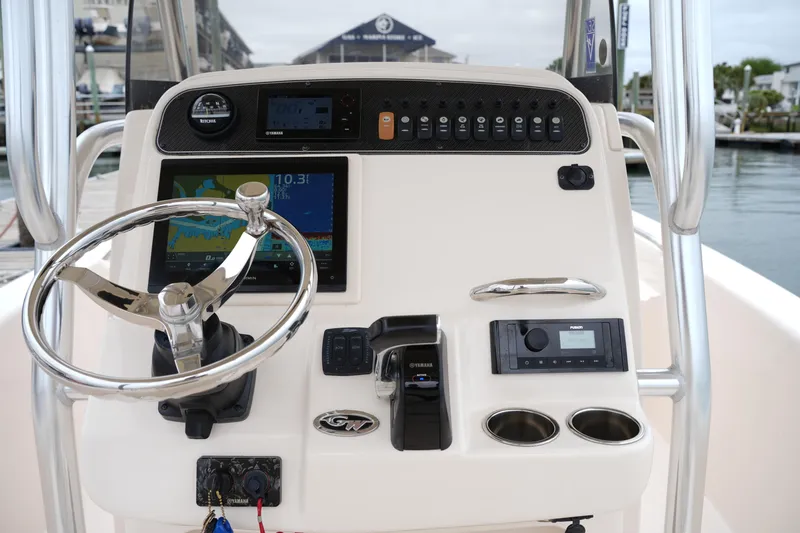 Slide: The Image of Control panel of 2015 Grady-White 251 Coastal Explorer boat with steering wheel and navigation instruments. - 23
