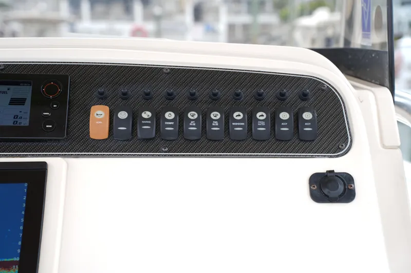 Slide: The Image of Control panel of 2015 Grady-White 251 Coastal Explorer boat with switches and display. - 27