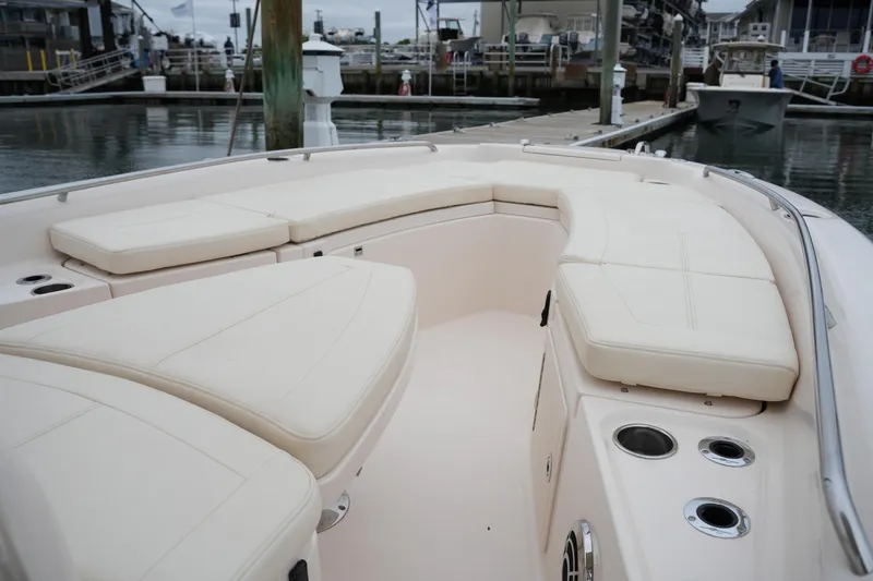 Slide: The Image of 2015 Grady-White 251 Coastal Explorer boat with spacious seating and cup holders at dock. - 32
