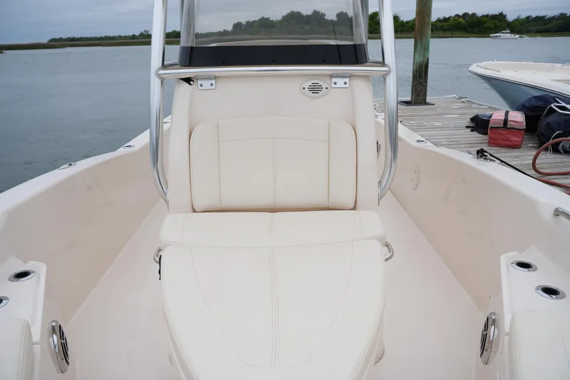 Slide: The Image of 2015 Grady-White 251 Coastal Explorer boat interior with seating, docked by the water. - 33