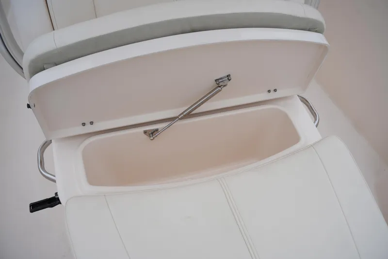 Slide: The Image of 2015 Grady-White 251 Coastal Explorer seat storage compartment open. - 34