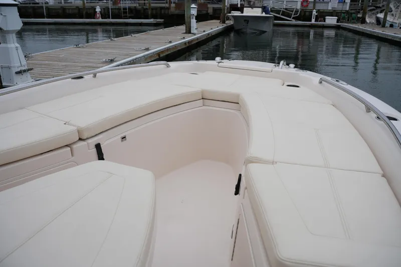 Slide: The Image of 2015 Grady-White 251 Coastal Explorer boat interior with cushioned seating at dock. - 35