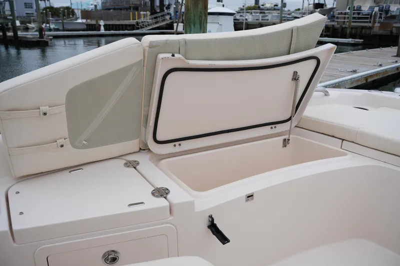 Slide: The Image of 2015 Grady-White 251 Coastal Explorer boat with open storage compartment at marina. - 37