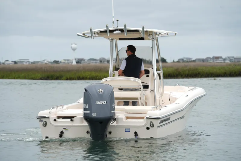 Slide: The Image of 2015 Grady-White 251 Coastal Explorer boat cruising on calm waters. - 6