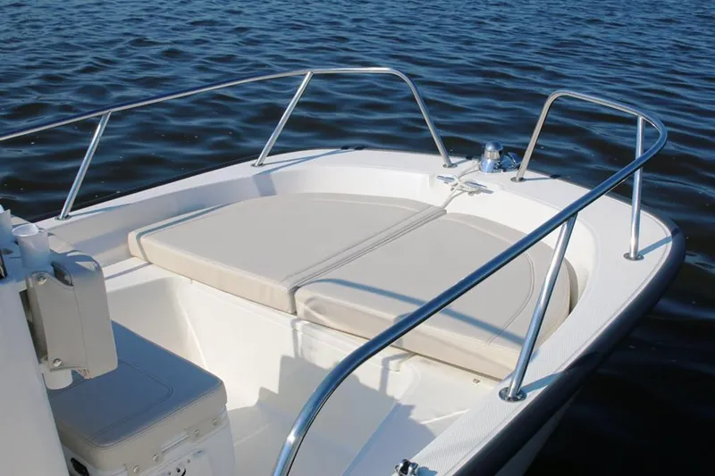 Slide: The Image of Manufacturer Provided Image: 2021 Boston Whaler 150 Montauk boat bow seating area on calm water. - 2
