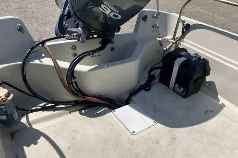 Slide: The Image of 1983 Boston Whaler 17 Montauk boat interior with Yamaha engine and battery setup. - 15