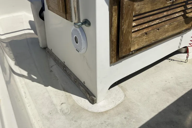 Slide: The Image of 1983 Boston Whaler 17 Montauk boat interior with wooden accents and speaker. - 18