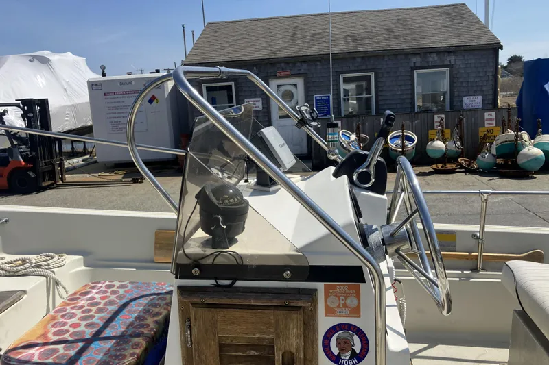 Slide: The Image of 1983 Boston Whaler 17 Montauk boat console with steering wheel and navigation equipment. - 20